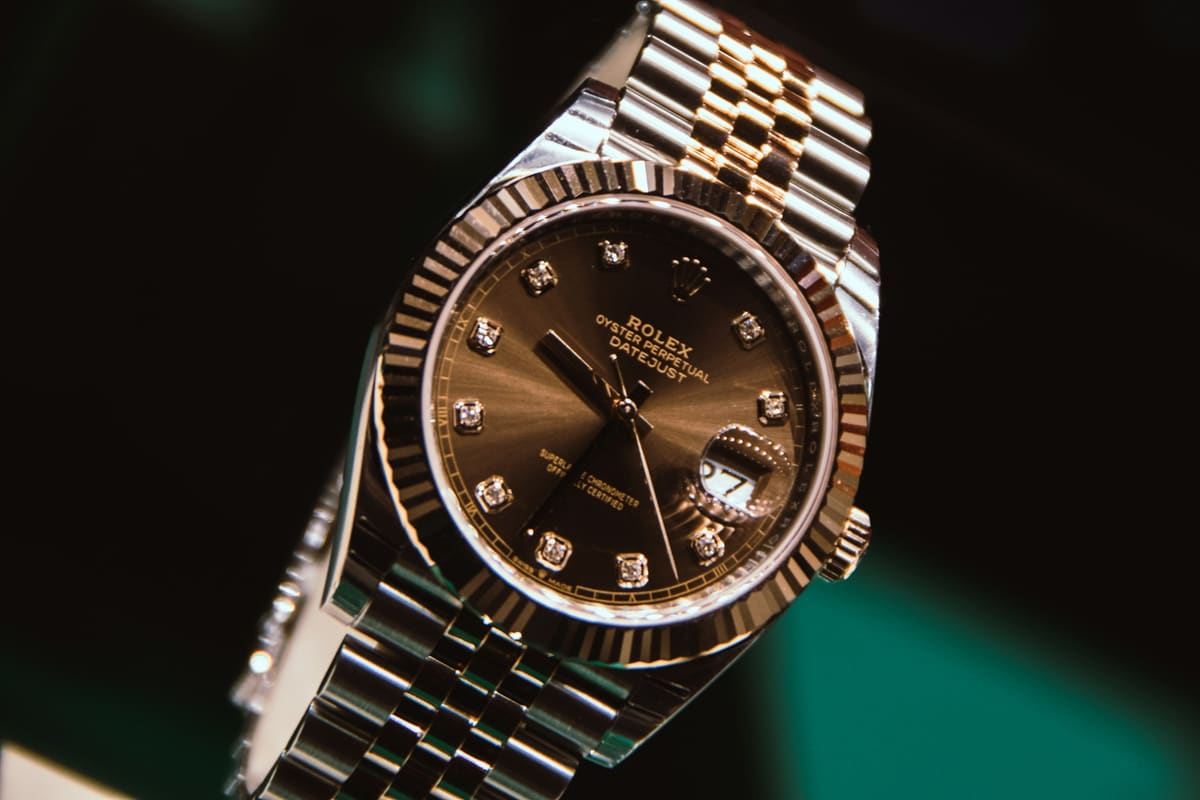 A steel and gold Rolex Datejust with a brown diamond dial