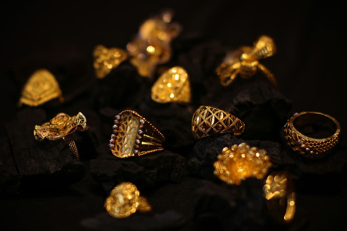 Ornate gold rings on pieces of charcoal