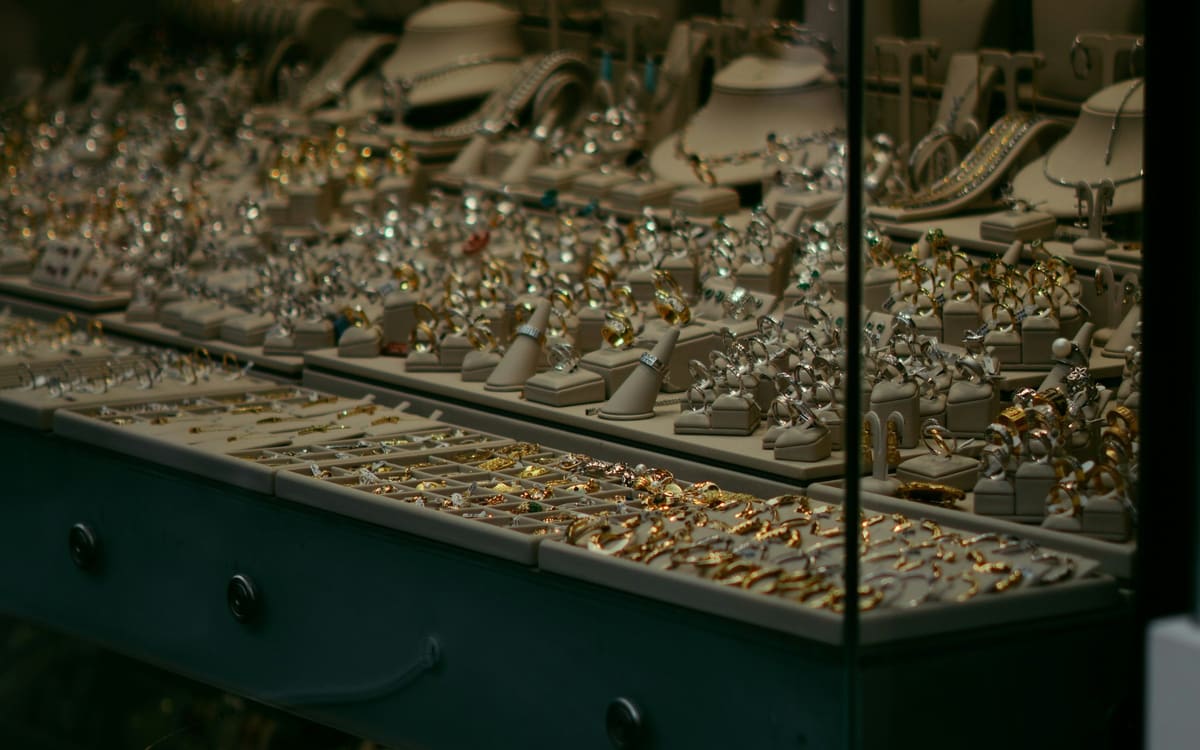A jewellery shop showcase full of gold rings, chains and earrings